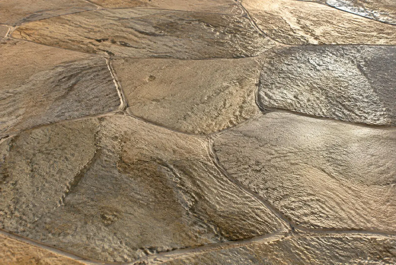 Close-up of textured stamped concrete with a natural stone pattern